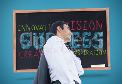 Composite image of smiling businessman standing