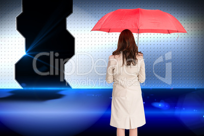 Composite image of businesswoman standing back to camera holding