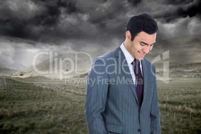 Composite image of smiling businessman standing