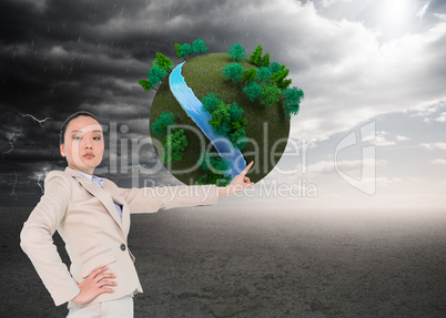 Composite image of unsmiling asian businesswoman pointing