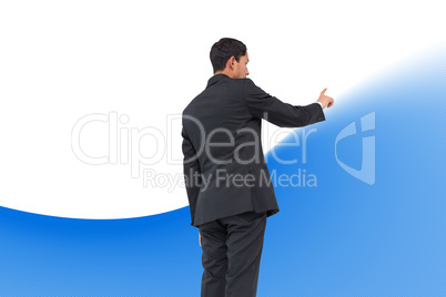 Composite image of serious asian businessman pointing