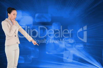 Composite image of thoughtful asian businesswoman pointing