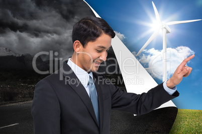 Composite image of smiling asian businessman pointing