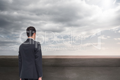 Composite image of businessman turning his back to camera