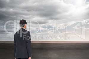 Composite image of businessman turning his back to camera