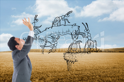 Composite image of stressed businessman with arms raised