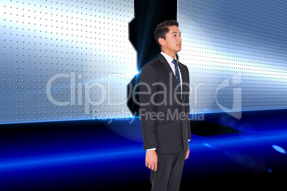 Composite image of stern businessman looking away