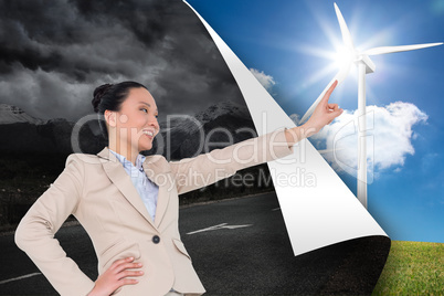 Composite image of smiling asian businesswoman pointing