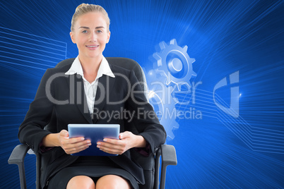 Composite image of businesswoman sitting on swivel chair with ta