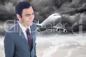 Composite image of smiling businessman standing