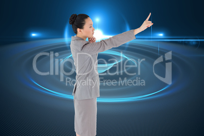 Composite image of unsmiling asian businesswoman pointing