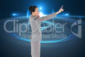 Composite image of unsmiling asian businesswoman pointing