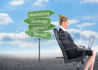 Composite image of businesswoman sitting on swivel chair with la