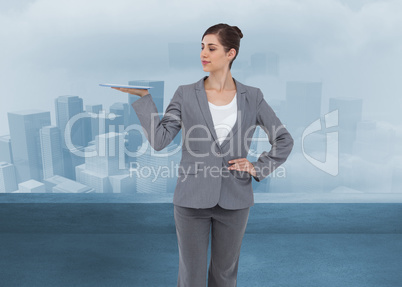 Composite image of businesswoman holding tablet computer