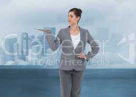 Composite image of businesswoman holding tablet computer