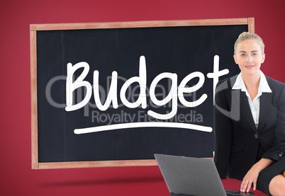 Composite image of businesswoman using laptop