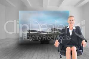 Composite image of businesswoman sitting on swivel chair in blac