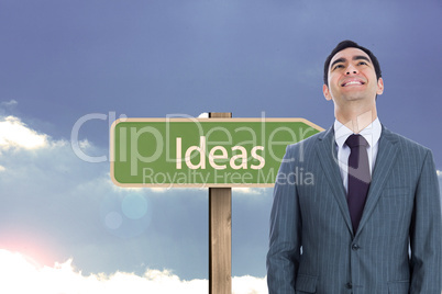 Composite image of smiling businessman standing