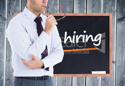 Composite image of unsmiling businessman holding glasses