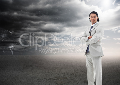 Composite image of serious office worker posing with the arms cr