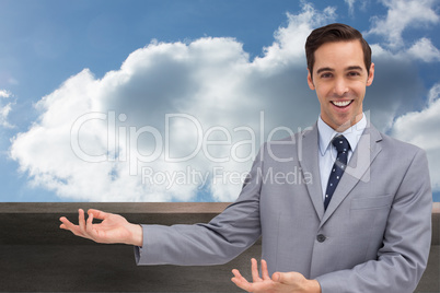 Composite image of young businessman presenting something