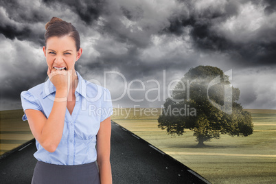 Composite image of furious businesswoman looking at the camera