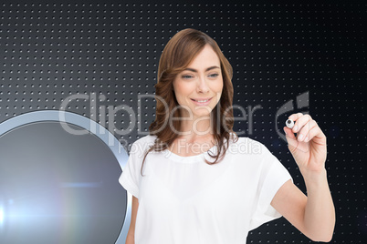 Composite image of smiling businesswoman holding marker