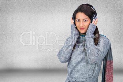 Composite image of beautiful model wearing winter clothes listen