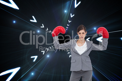 Composite image of businesswoman with boxing gloves