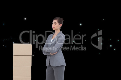 Composite image of thoughtful woman with cardboard boxes