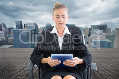 Composite image of businesswoman sitting on swivel chair with ta