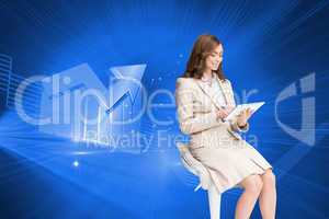 Composite image of happy businesswoman using tablet