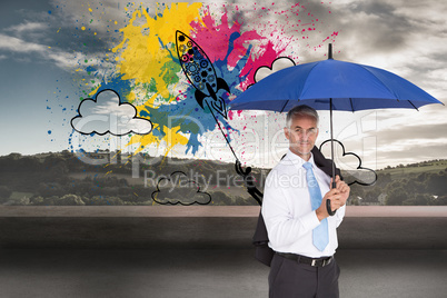 Composite image of businessman holding blue umbrella