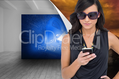 Composite image of happy brunette using smartphone