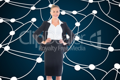 Composite image of businesswoman standing with hands on hips