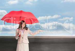 Composite image of happy businesswoman holding umbrella