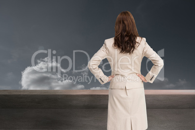Composite image of businesswoman standing back to camera