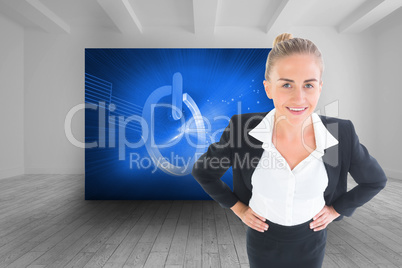 Composite image of businesswoman standing with hands on hips