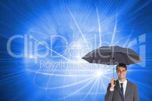 Composite image of happy businessman holding grey umbrella