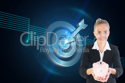 Composite image of businesswoman holding pink piggy bank