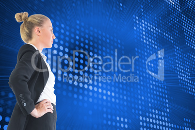 Composite image of businesswoman standing with hands on hips