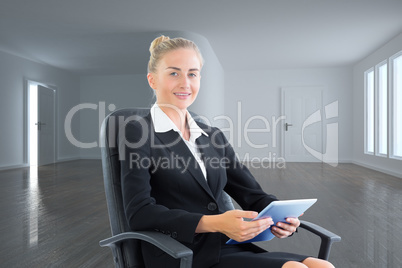 Composite image of businesswoman sitting on swivel chair with ta