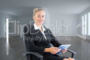 Composite image of businesswoman sitting on swivel chair with ta