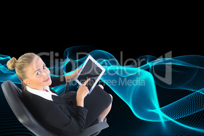 Composite image of businesswoman sitting on swivel chair with ta