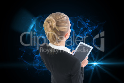 Composite image of businesswoman holding new tablet