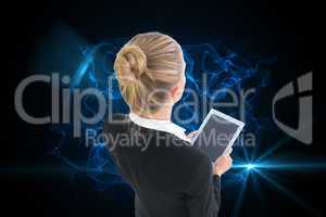 Composite image of businesswoman holding new tablet