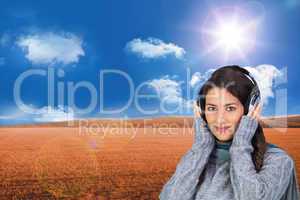 Composite image of beautiful model wearing winter clothes listen