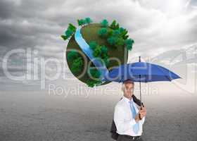 Composite image of businessman holding umbrella smiling at camer
