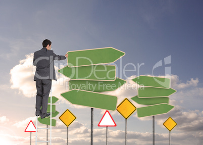 Composite image of businessman standing on ladder