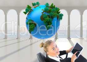 Composite image of businesswoman sitting on swivel chair with ta